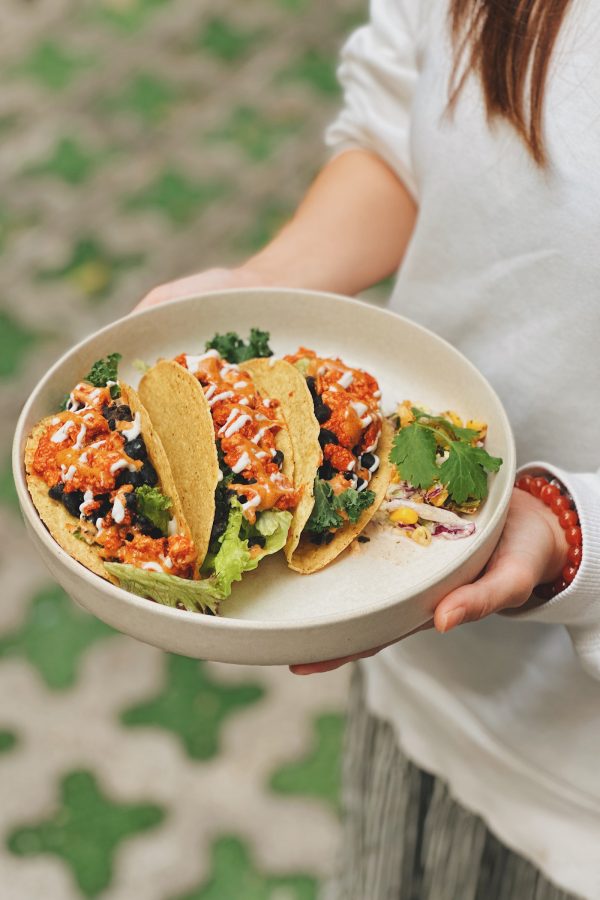 A closeup of a vegan Mexican taco served with organic salad and homemade tofu paste at Wanaka vegan cafe.