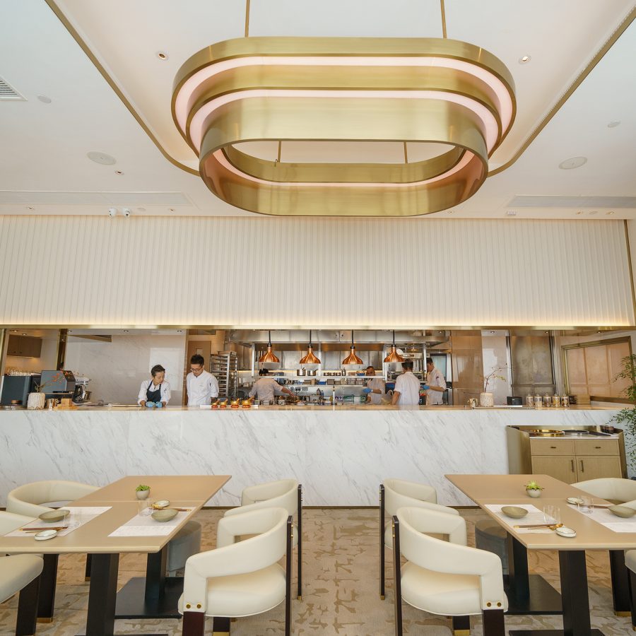 Interior view of Yuan restaurant with open kitchen with staff behind the counter.