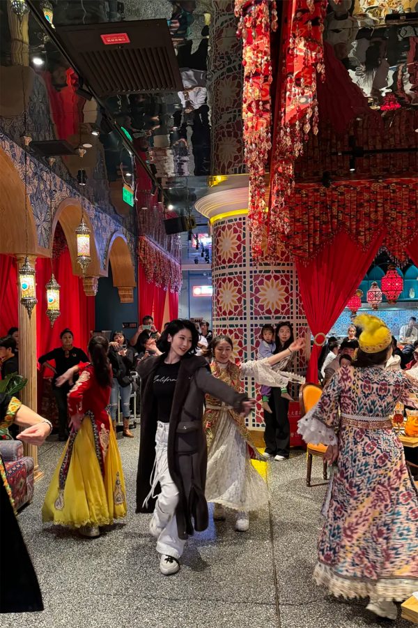 Diners and staff dance inside the richly decorated Ma Fenghua Xinjiang Cuisine.
