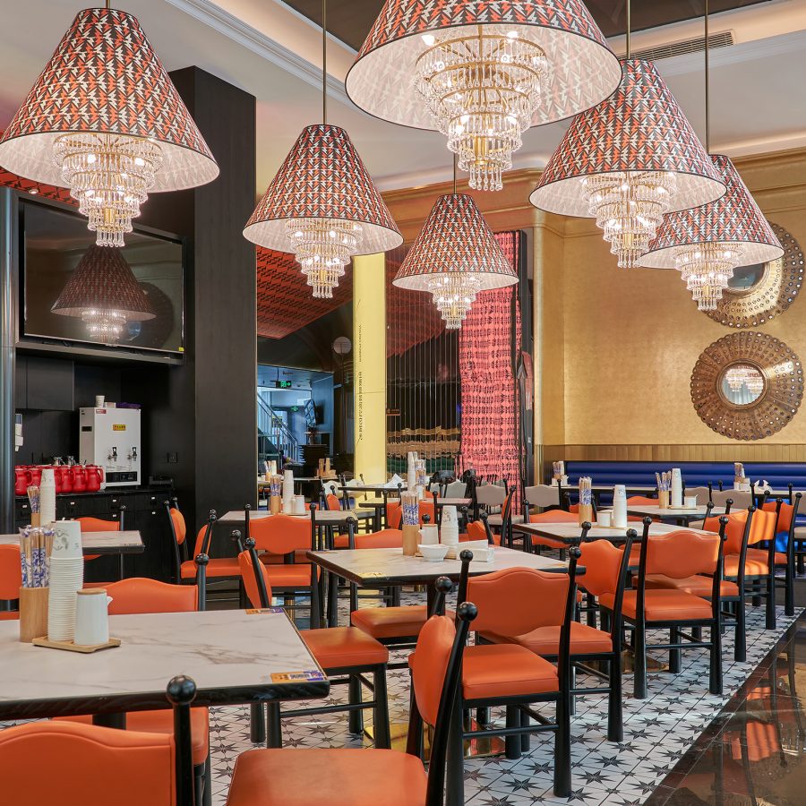 The interior of Daidaide Jia Ge Mian in Xinjiang features bright decor, from the chairs and walls to the lights. 