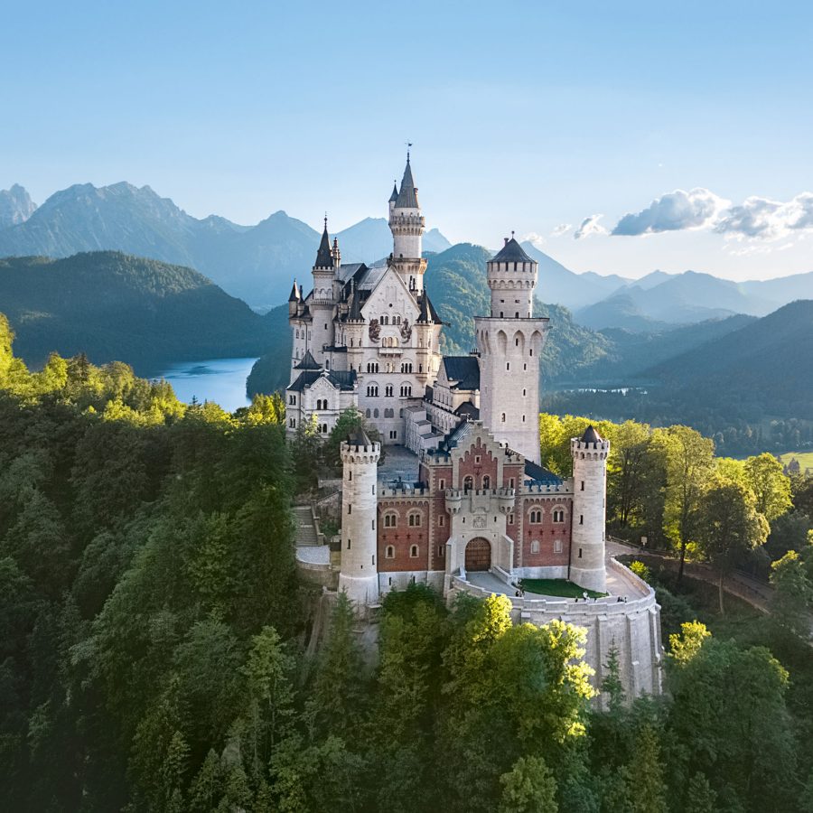 Daytime view of Neuschanstein Castle from a distance.