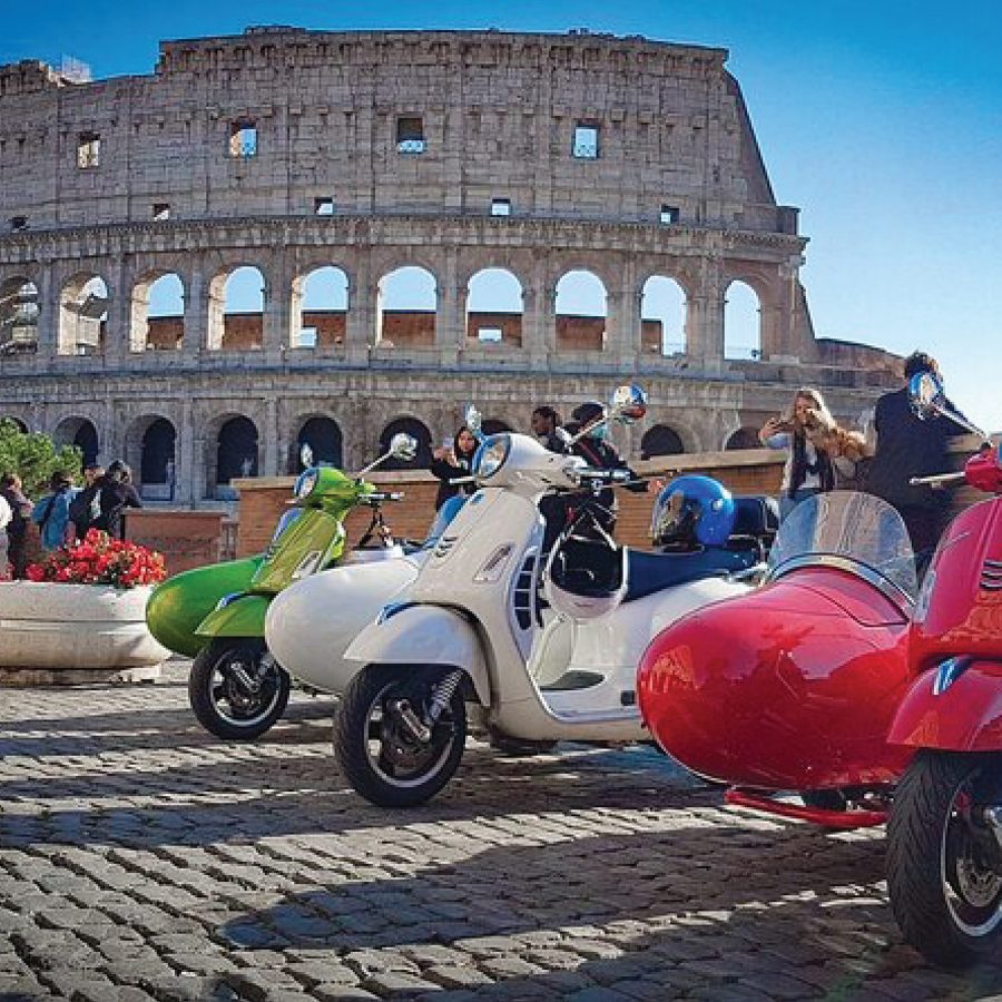 Vespas lined up outside the Colosseum in Rome.   