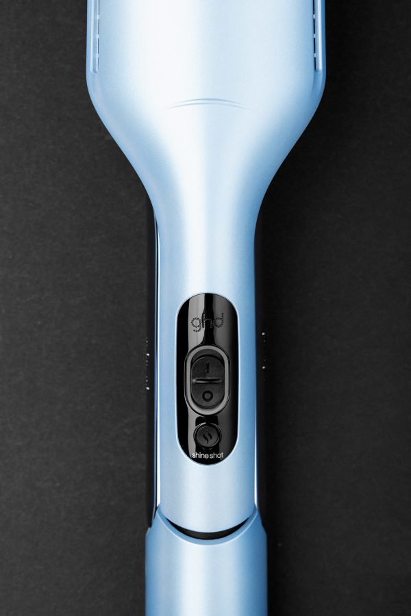 Close-up of the power button on the Ghd Iced Luxe Duet Style. 