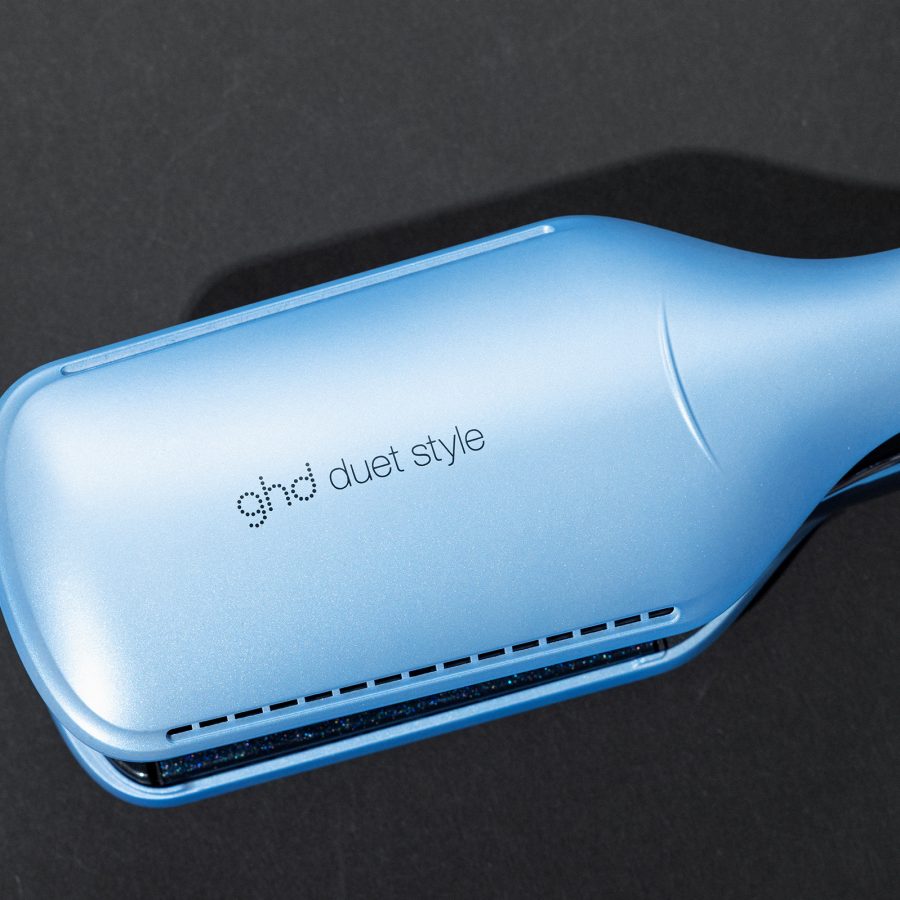The back of the Ghd Iced Luxe Duet Style against a black surface.