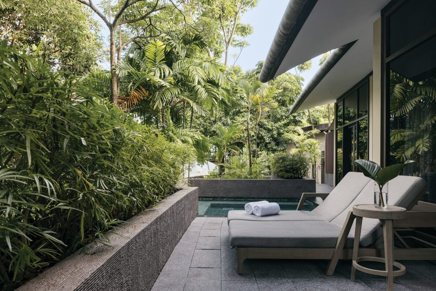 Deck chairs next to a private pool at a villa in Capella Singapore. 
