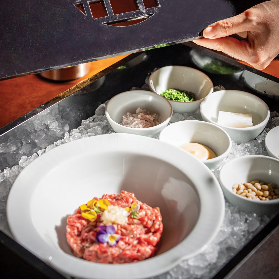 A tray of side dishes and a colourful main dish at the Four Seasons Seoul.