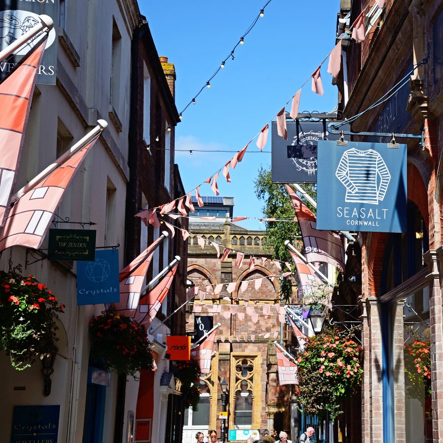 Flags, signs and bunting hang over a street in Exeter. 