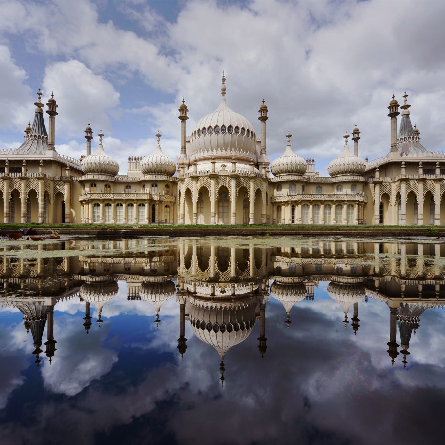 Brighton’s Royal Pavilion & Garden reflects onto the water on a cloudy day.  