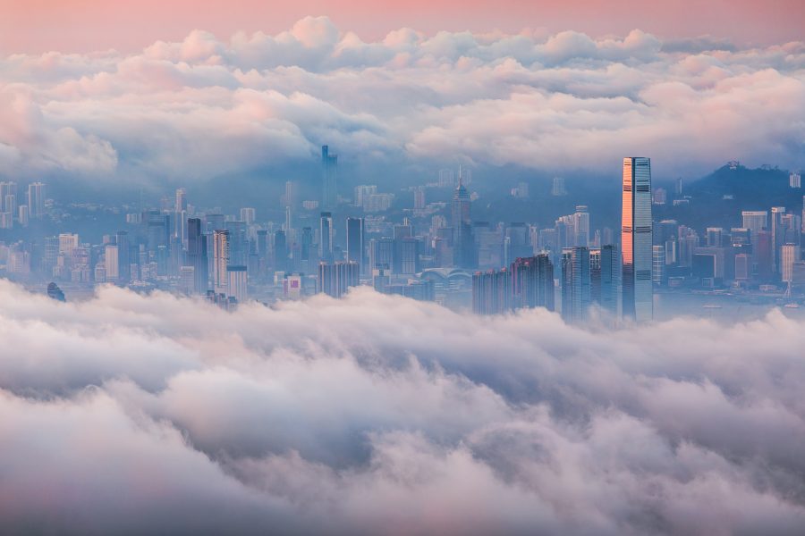 View of the Hong Kong skyline partially obscured by rolling clouds. 