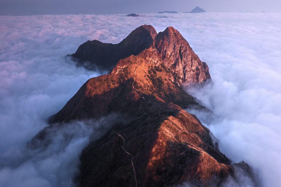 Mountains peek through a sea of clouds in Hong Kong.  