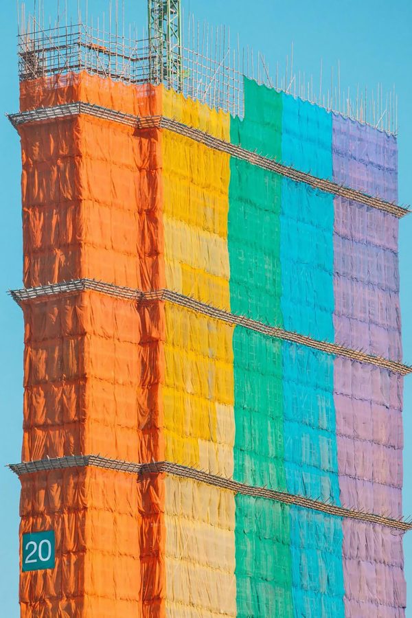 Rainbow scaffolding obscures a building in Hong Kong.