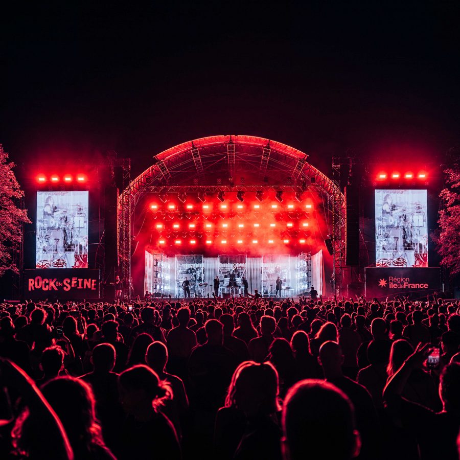 Red lights blare on the Rock en Seine mainstage in Paris.