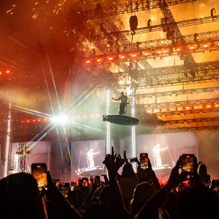 A musician stands on a platform hanging over the crowd at Wireless Festival.