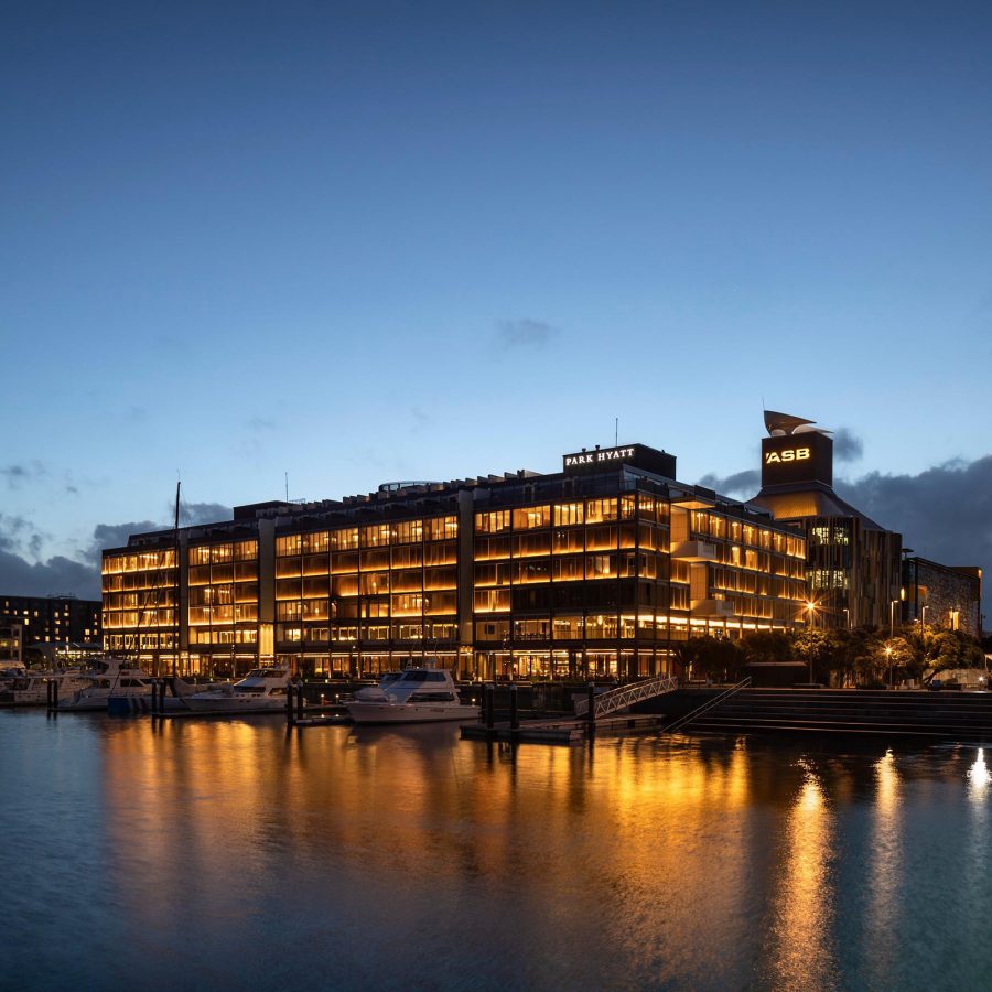 Exterior view of The Park Hyatt at dusk, with the Viaduct Basin in the foreground.