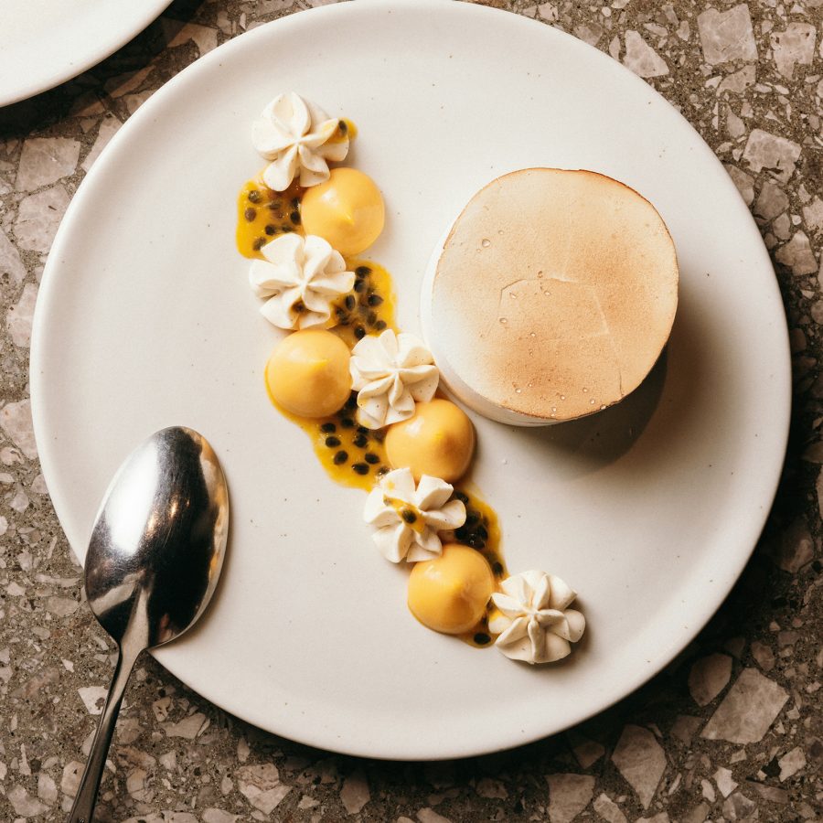 Closeup view of a meringue dessert with a garnish of passion fruit at The Lodge Bar & Dining. 