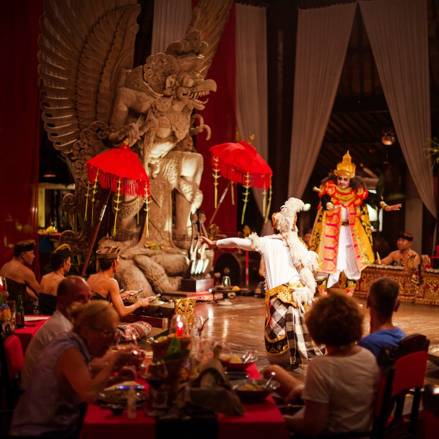 People are gathered to watch performers dancing in the spotlight. 