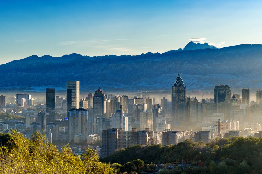 A shot of Urumqi’s buildings and mountains at sunrise.