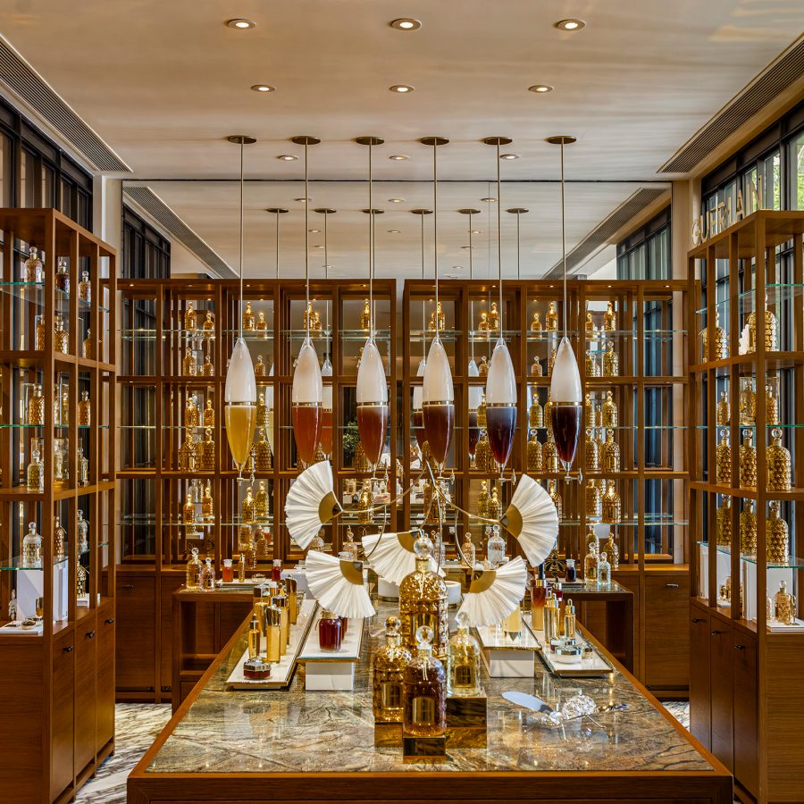 A room with shelves of gold bottles of skincare and fragrance at Asaya Spa by Guerlain in Rosewood Hong Kong. 