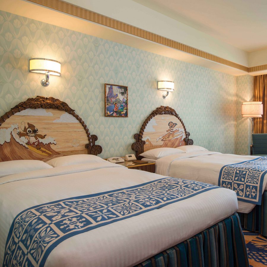 A guest room at Disney Ambassador Hotel, Tokyo features two guest beads with Disney character-themed headboards and artworks.