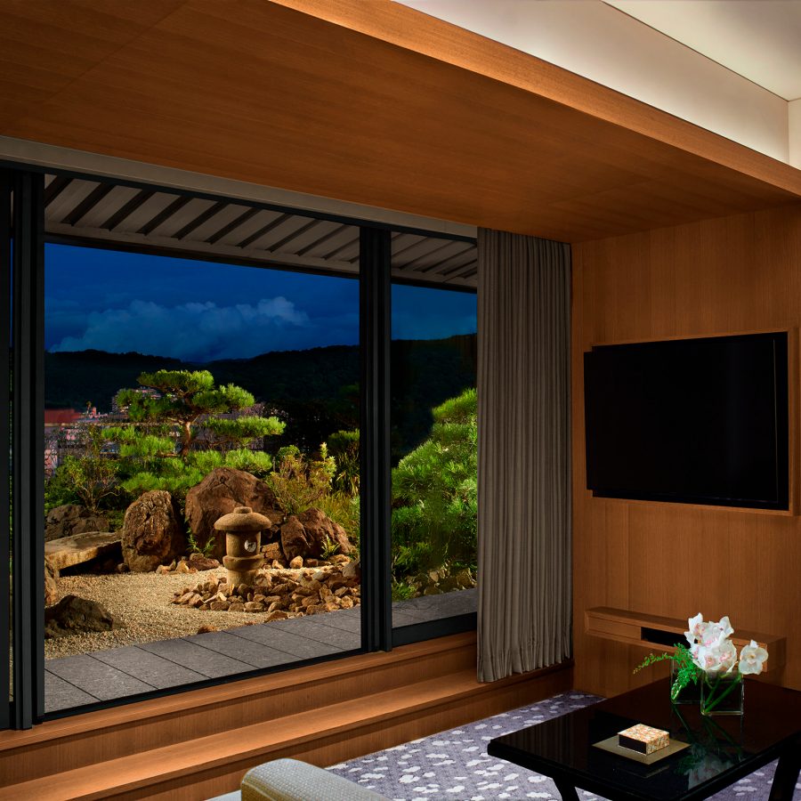 Interior view of a room in The Ritz-Carlton, Kyoto and the zen garden outside. 