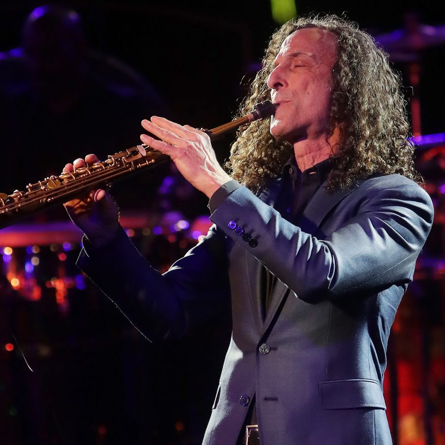 Kenny G plays the soprano saxophone onstage.