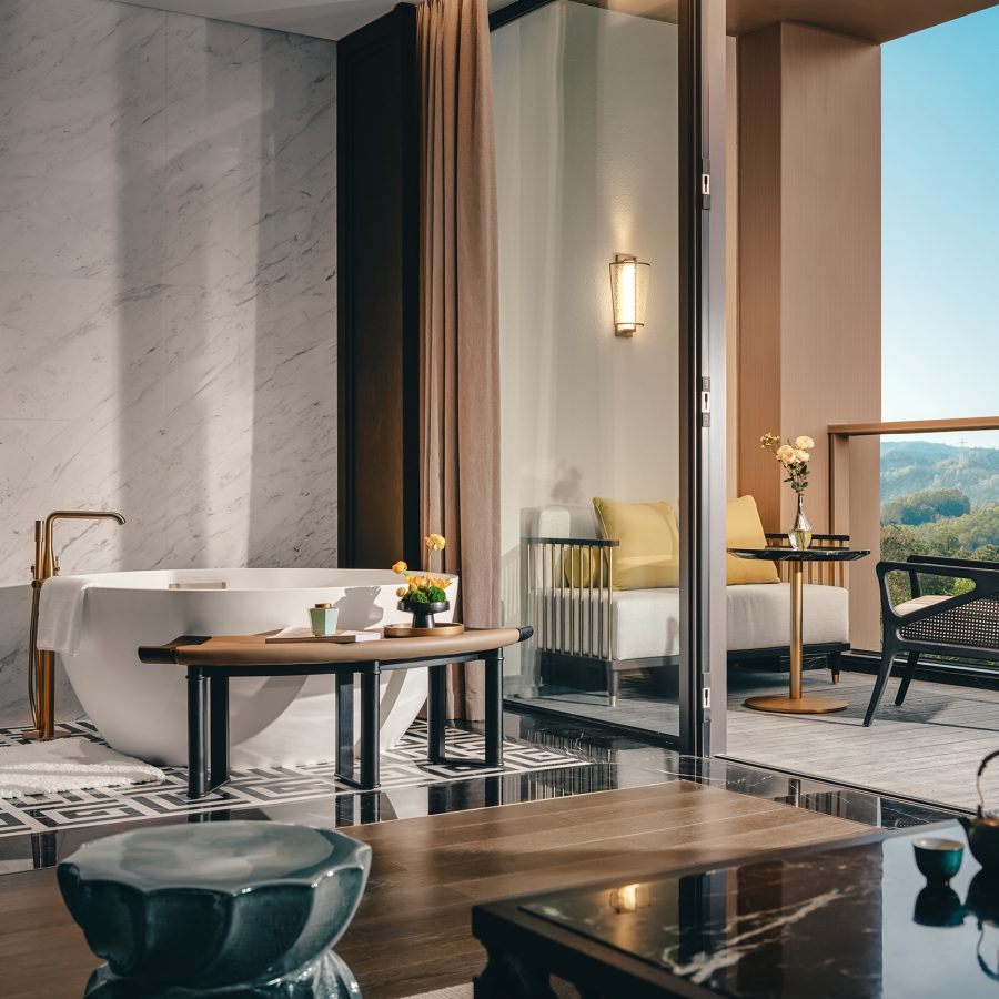 The interior of a guest room at MGM Reserve Zhuhai is spacious and decorated with sleek furniture.d