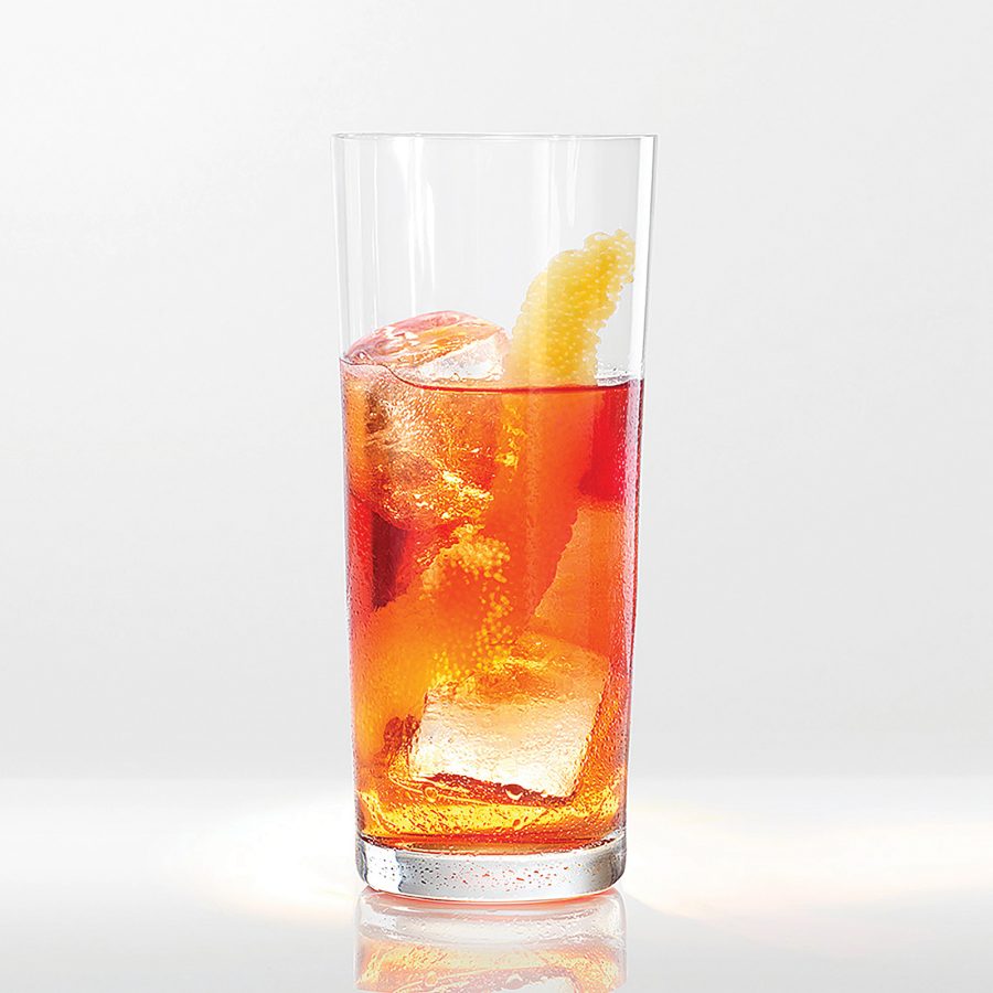 Close-up view of a Negroni in a tall glass.