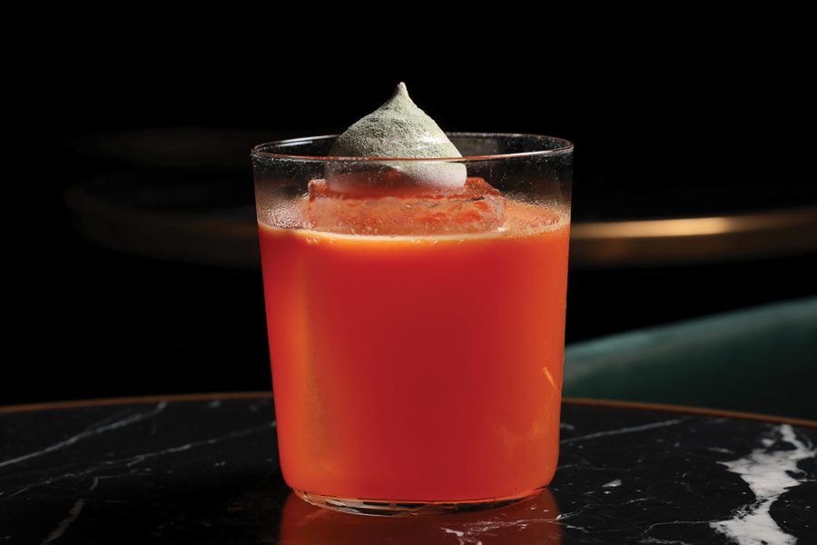 Close-up view of an orange-coloured Tommy’s margarita cocktail in a short tumbler