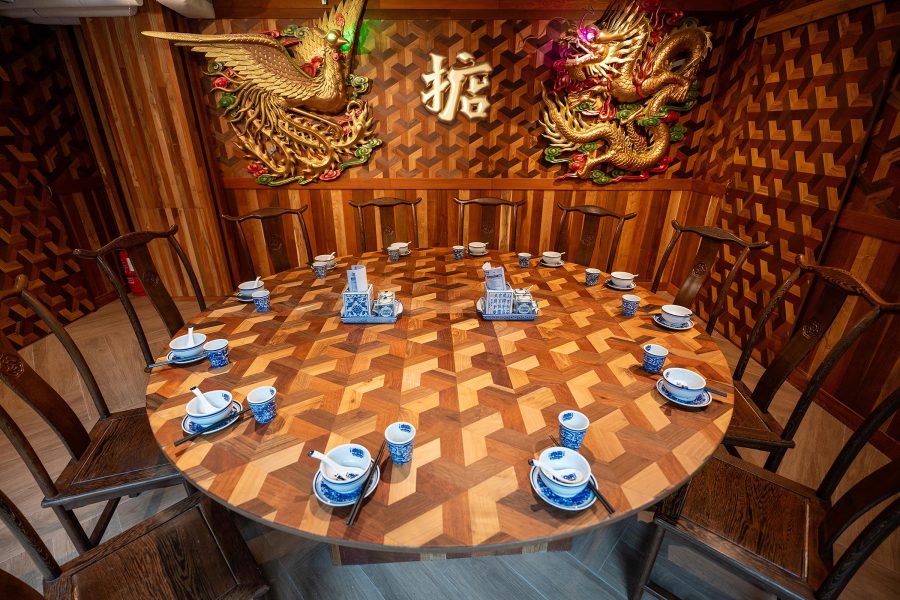 Modern interior design of the private dining room with wooden round table and chairs at lulu BaoBao