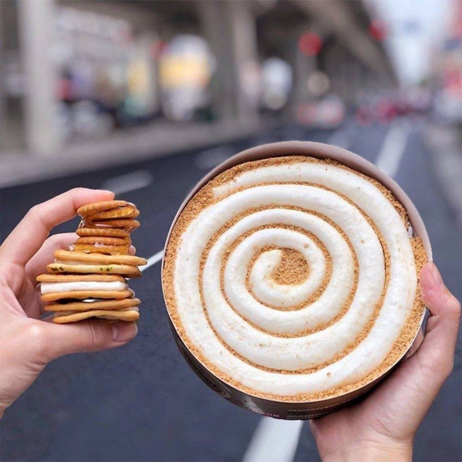 A person holds Taiwanese snacks such as malt candy in their hands.  