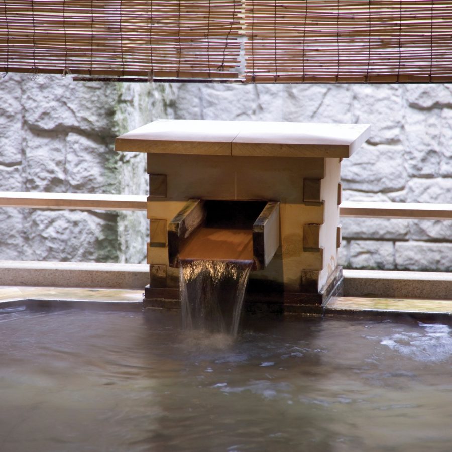 Water flowing into a hinoki tub at Yamashiro Onsen in Kaga.
