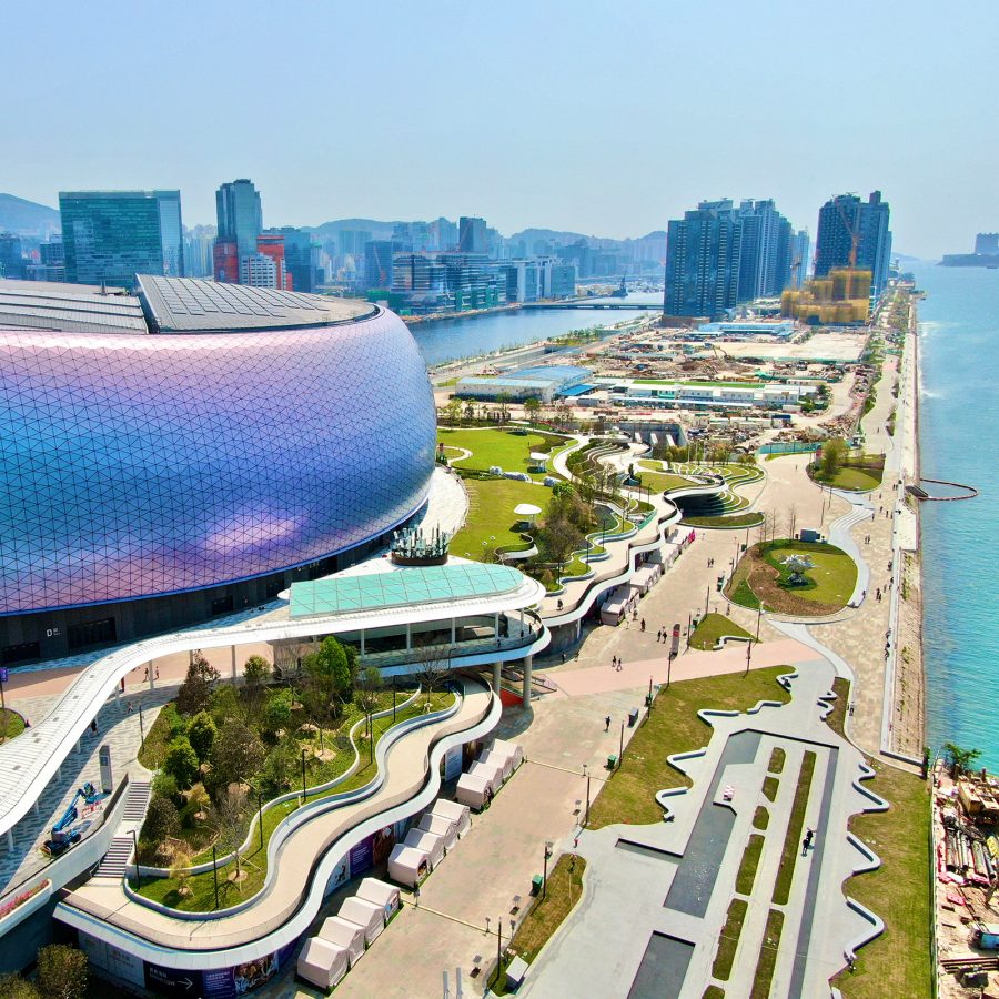 Kai Tak Stadium’s iridescent exterior and its neighbouring waterfront park are visible from the air.