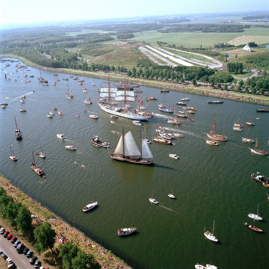 A sea of historic ships, naval vessels, sailing ships and tall boats, IJ Harbour in Amsterdam, Netherlands during daytime 