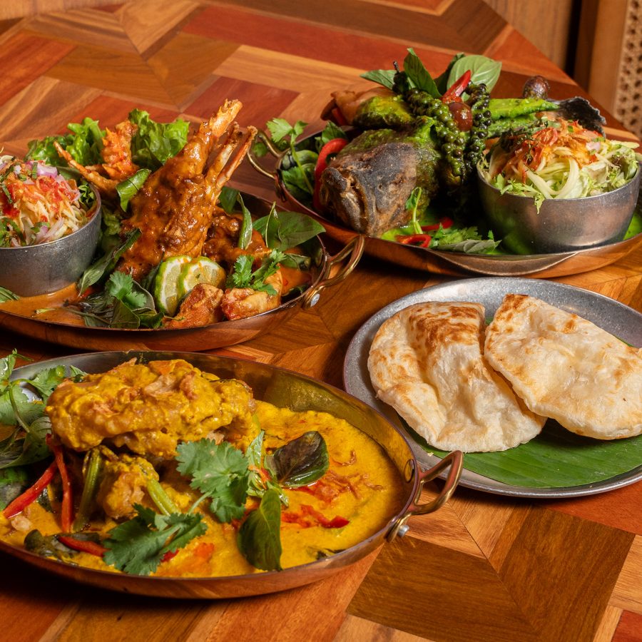 A spread of four dishes, curry seafood and roti served at padpad THAI