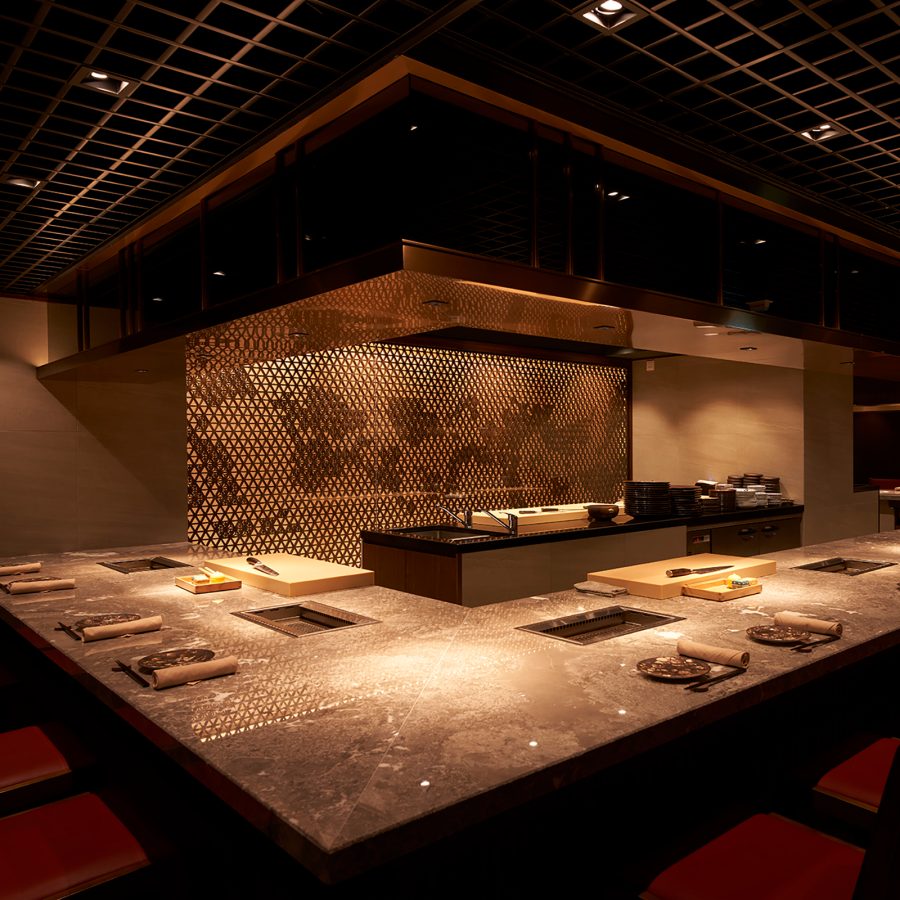 Dim lighting and view of the open kitchen and interior of Yakiniku Ushio 