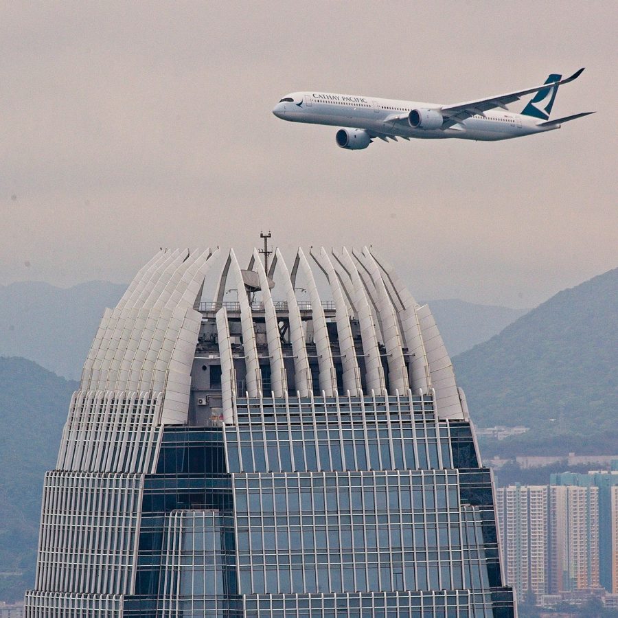 A plane is seen flying over the top of the IFC. 