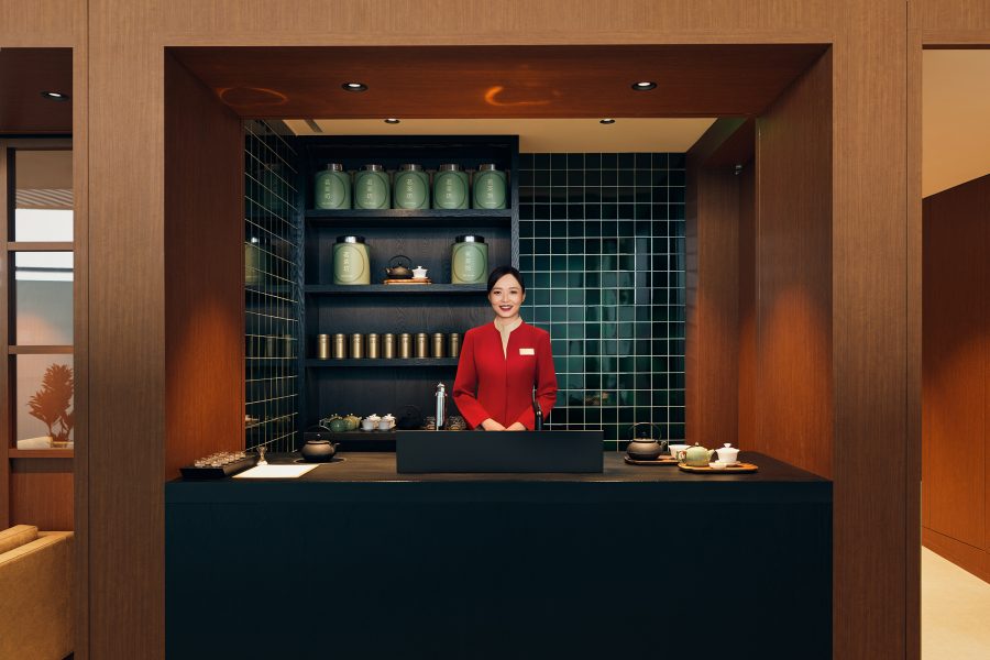 A female Cathay Pacific ground crew behind the counter of the Teahouse in the Beijing Cathay Pacific lounge.