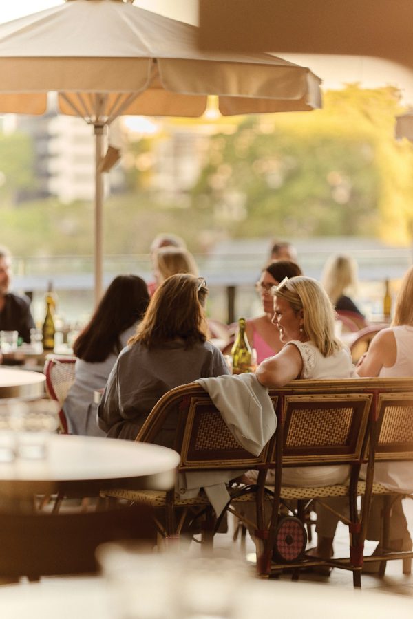 A group of women sitting at a table outside at Bar Miette in Brisbane.