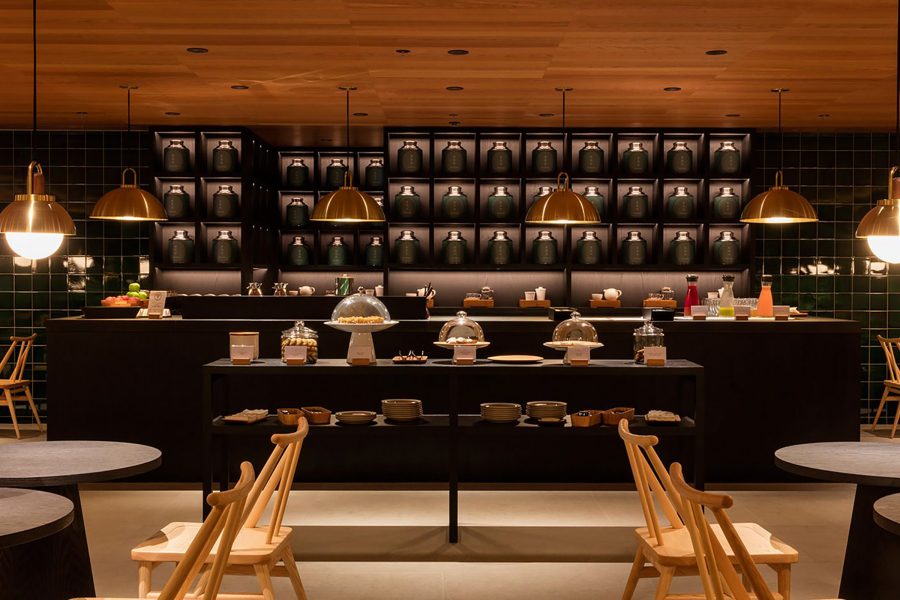A table and countertop in Cathay airport lounge The Pier, First surrounded by chairs and tables on either side.
