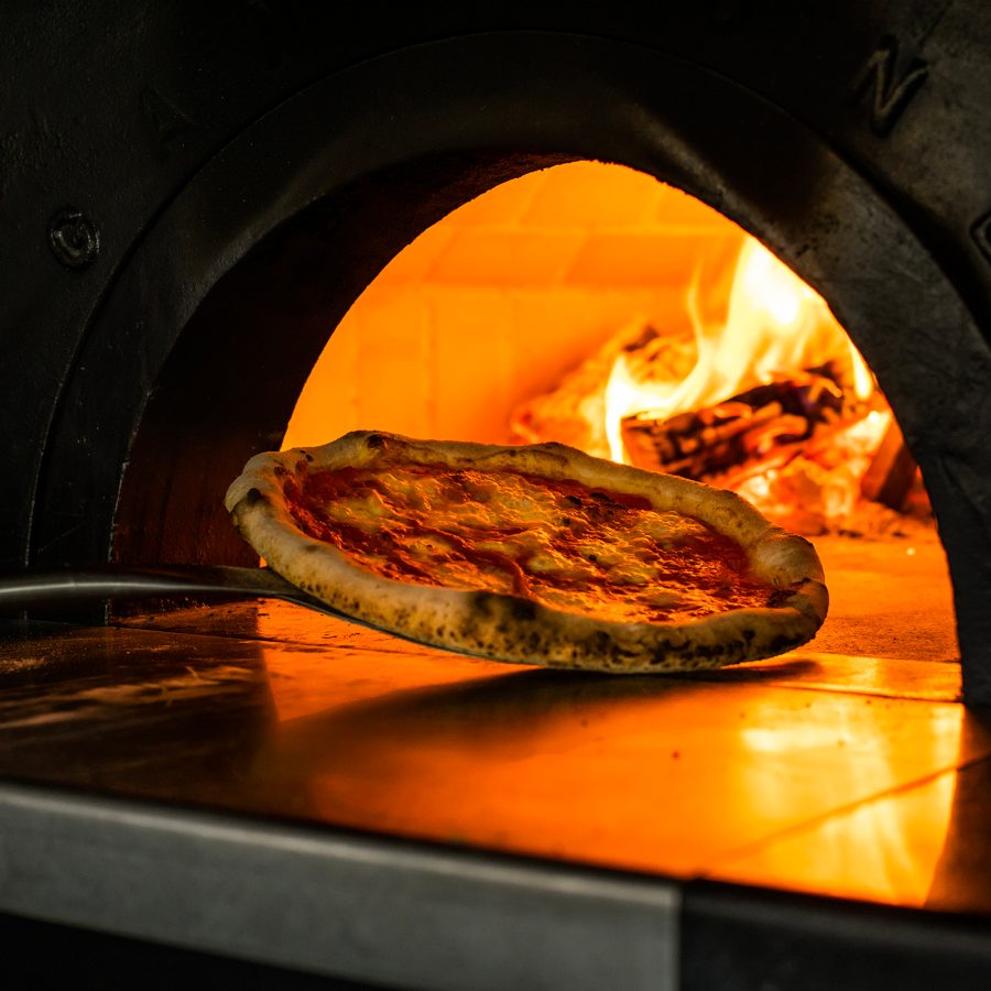A pizza in a wood oven at Mr. Maurice’s Italian Restaurant & Rooftop Bar in Ace Hotel Kyoto. 