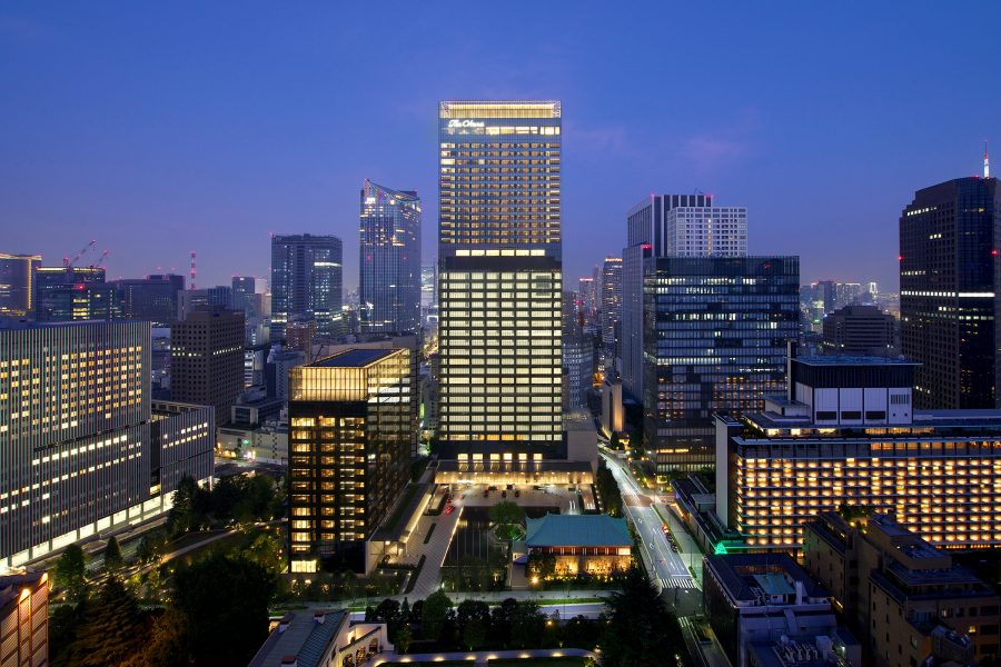 Exterior view of The Okura Tokyo hotel at dusk.