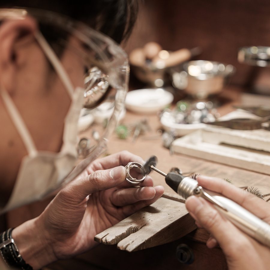 Interior view of a person making a piece of jewellery at The Boring Class.