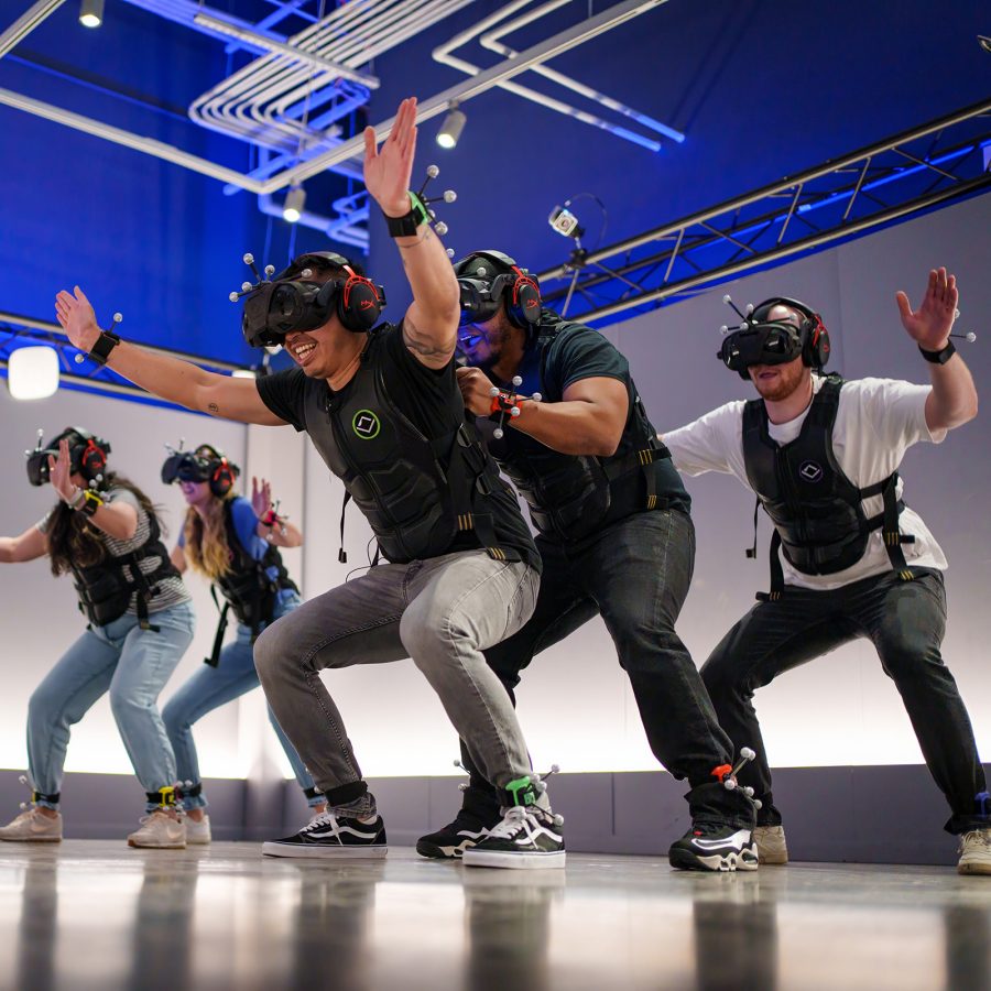 Interior view of a group of people engaging in an immersive VR experience at Sandbox VR.