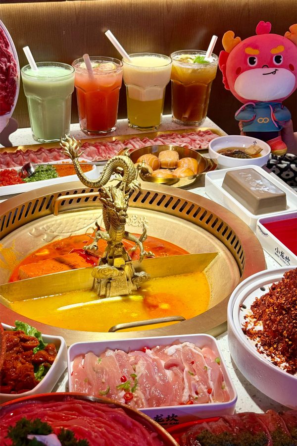 A closeup of a hotpot with various meats and drinks at Shoo Loong Kan, Hong Kong. 