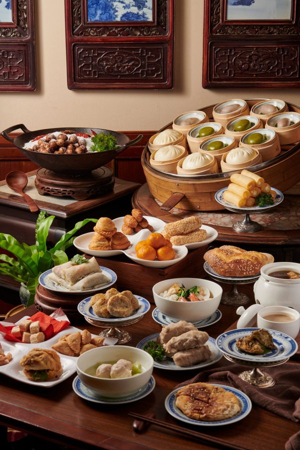 Plates and steamers of dim sum are crammed onto a table for display at Qinyuan.