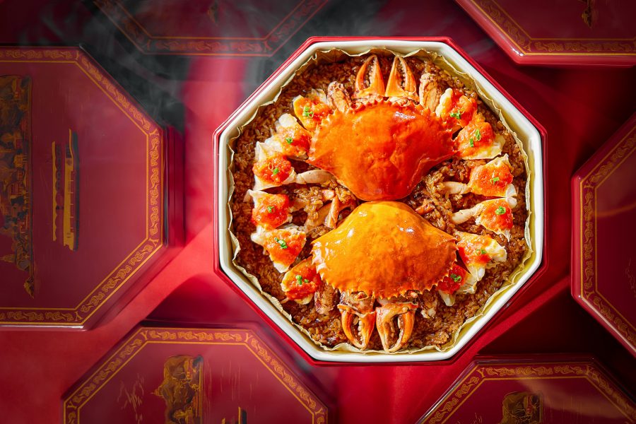 A hexagonal dish holds steamed crab on top of glutinous rice at Yanyu. 