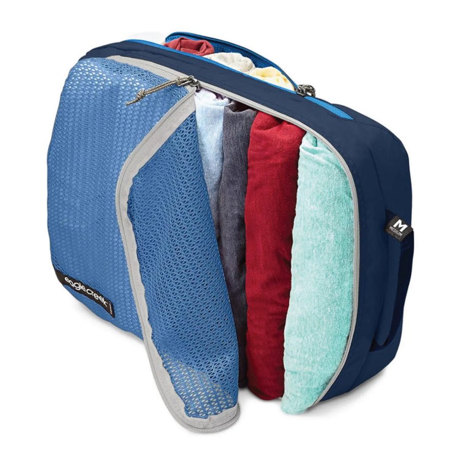 A product shot of Eagle Creek’s packing cube shows several rolled shirts inside. 