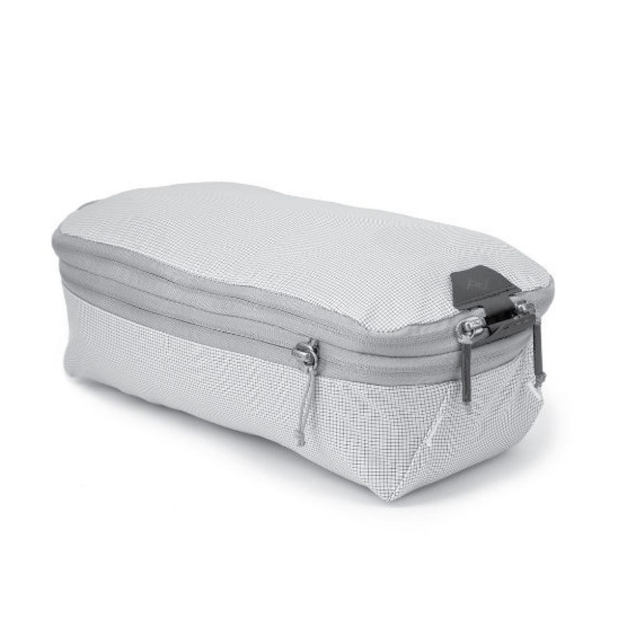 A product shot of Peak Design’s packing cubes shows a light grey rectangular zippered bag. 