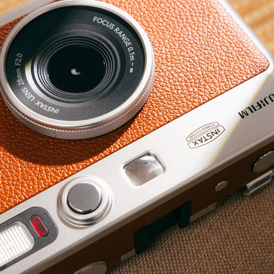 Close up on the lens and body of the Fujifilm Instax Mini Evo.
