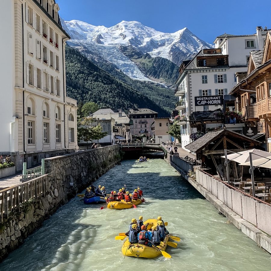 A group of travellers in rafts paddle down a canal at Chamonix, France. 